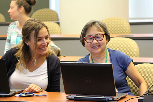 2 ladies looking at a laptop